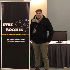 CEO Rahul Vasisht stands next to a banner with the StatRookie logo as his booth from MIT Sloan Analytics Conference in 2019.